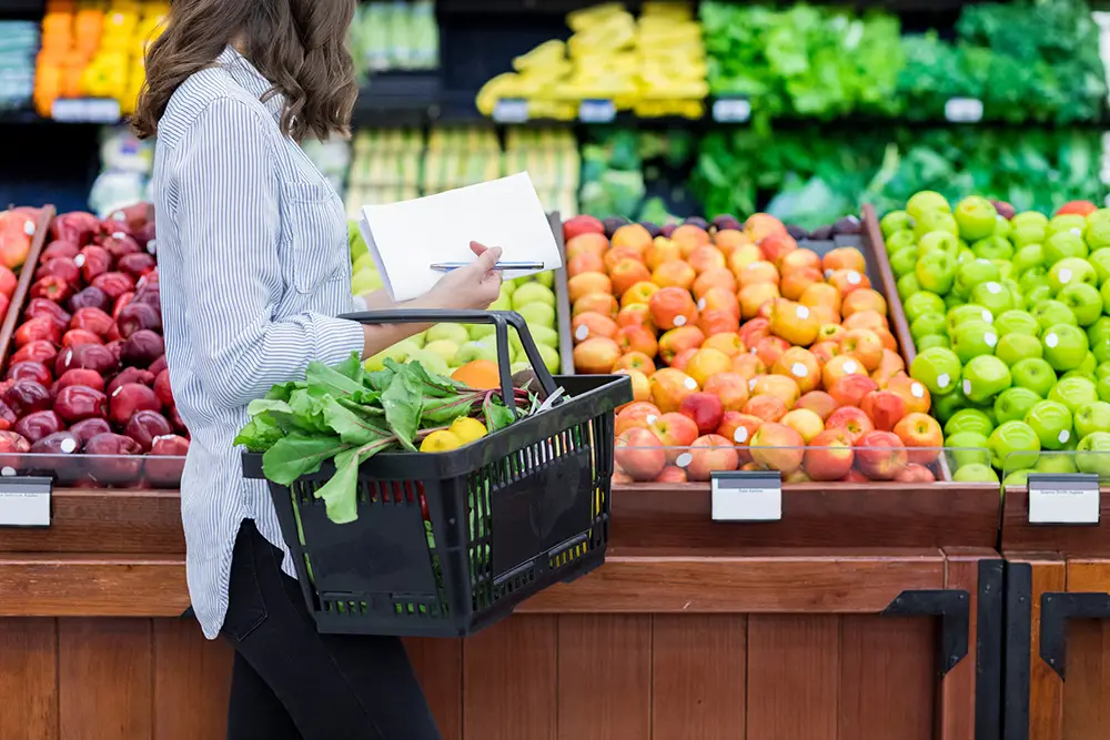 consumer-shopping-with-grocery-list-in-grocery-store-with-basket
