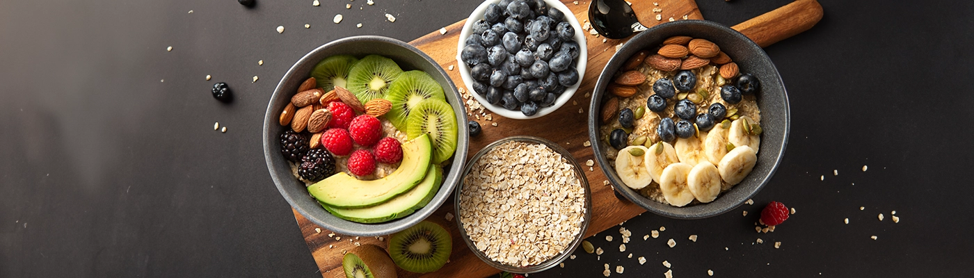 fruits and oats and oatmeal on a wooden board