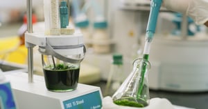 Lab equipment with dark green liquid.
