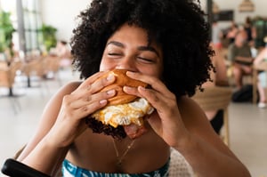 Consumer eating burger