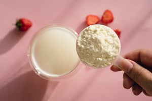 GettyImages-2217198477 protein powder scoop with berries (1)