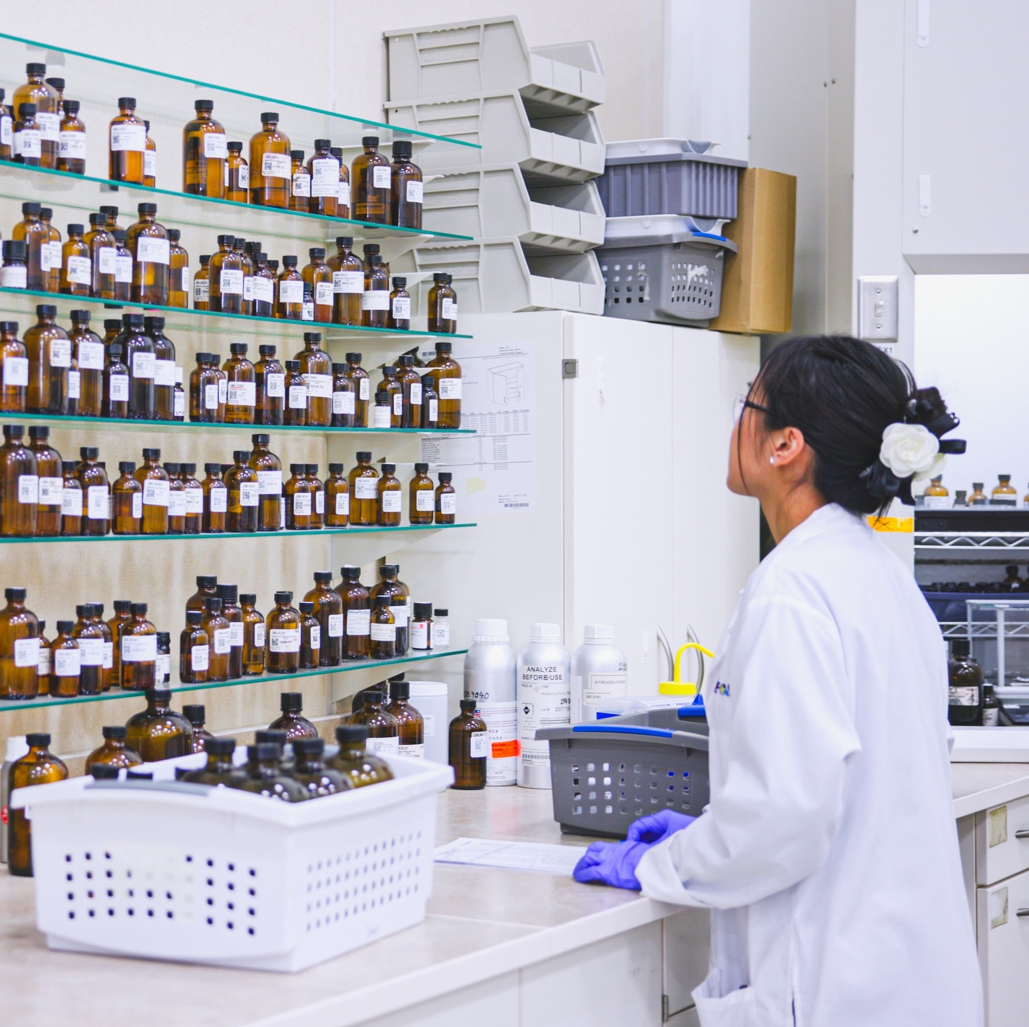 Lab technician looking at shelves of flavor samples